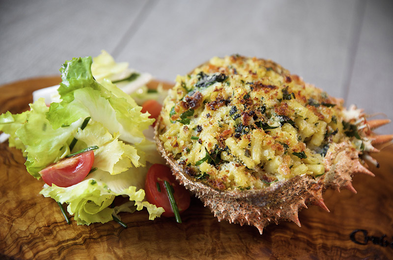 Spider crab with cheese topping and salad