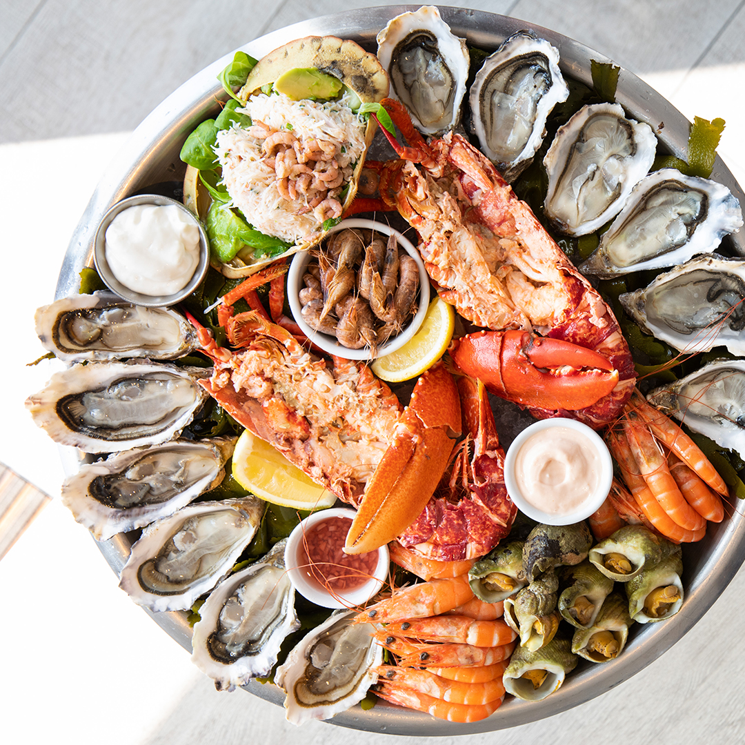 A seafood platter with local seafood including oysters, lobster, whelks and prawns