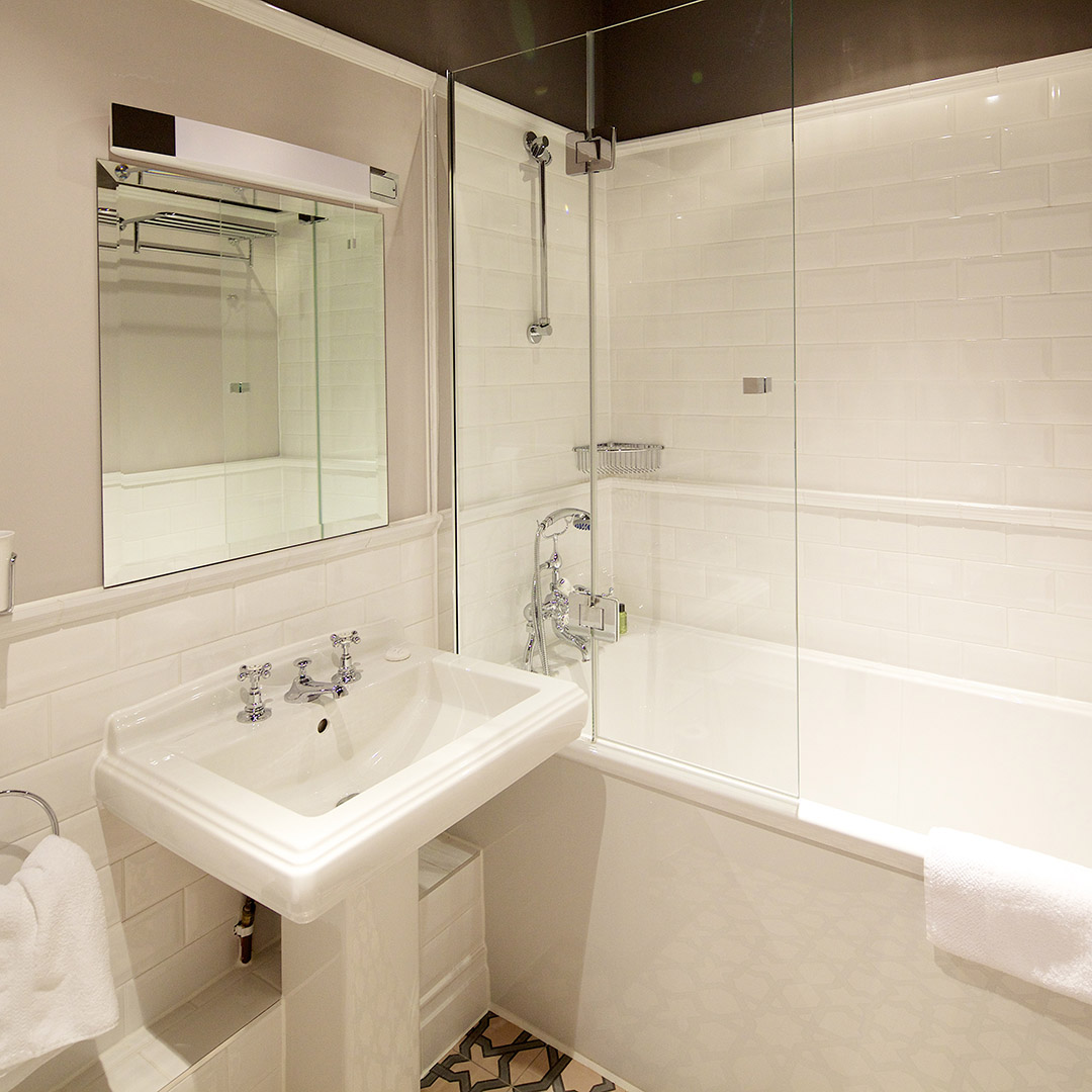 Large tiled bathroom with bath tub